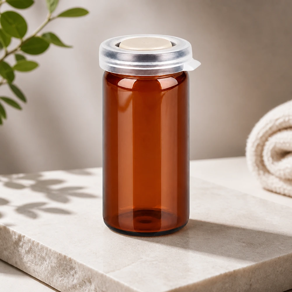 UV-beschermend glas met opgerolde rand, 10 ml, bruin met wit binneninzetstuk in de klikdop